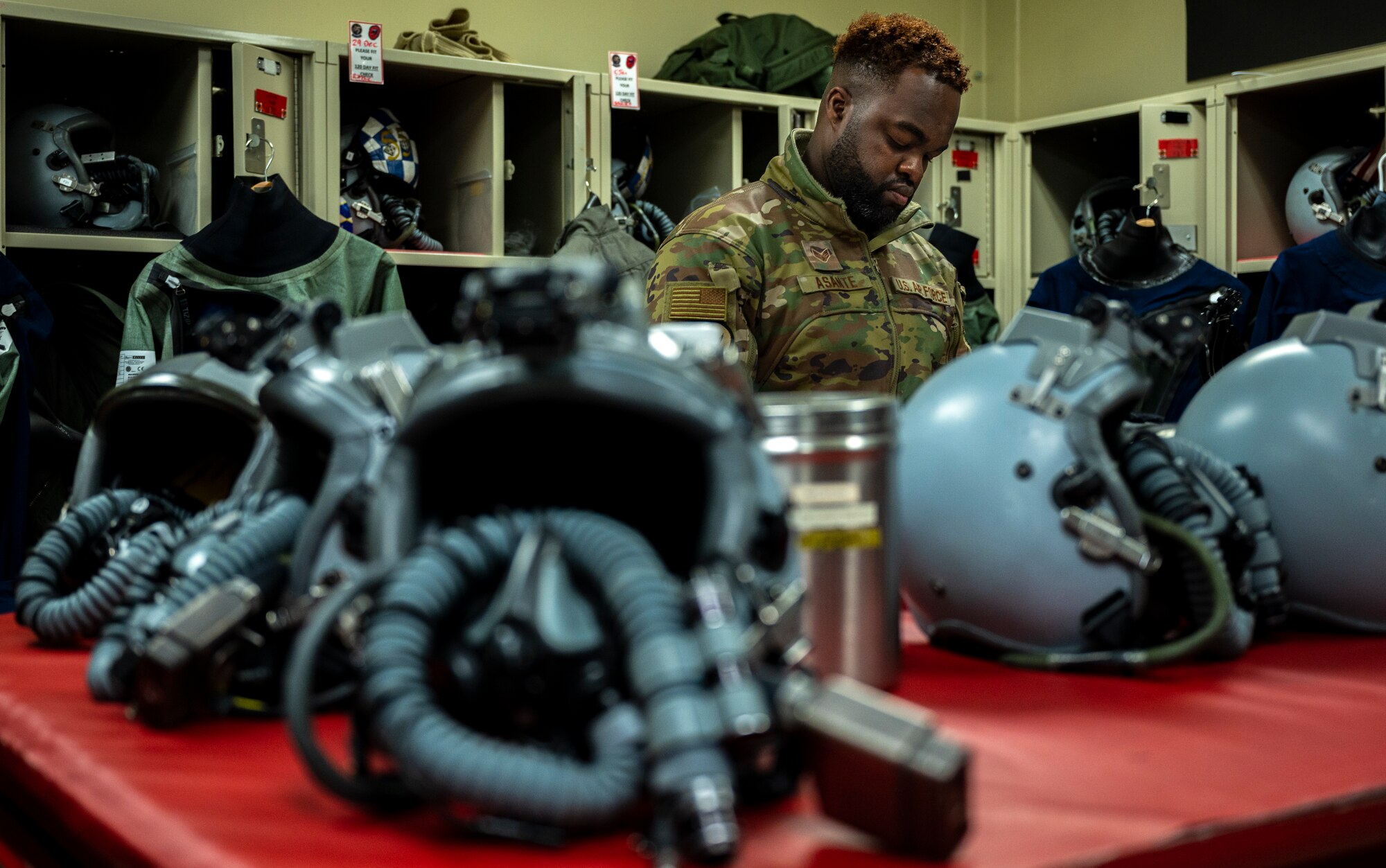 U.S. Air Force Senior Airman Joseph Asante, 51st Operations Support Squadron aircrew flight equipment (AFE) journeyman, performs pre-flight inspections on flight equipment at Osan Air Base, Republic of Korea, Dec. 8, 2022.