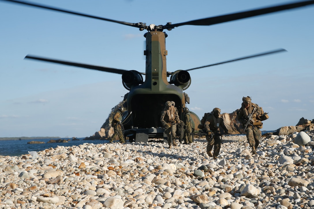 U.S. Marines with 1st Battalion, 2d Marines and members of the Japan Self-Defense Force Amphibious Rapid Deployment Brigade offload a Japan Self Defense Force CH-47JA Chinook helicopter during Keen Sword 23 at Tsutara, Japan, Nov. 16, 2022.