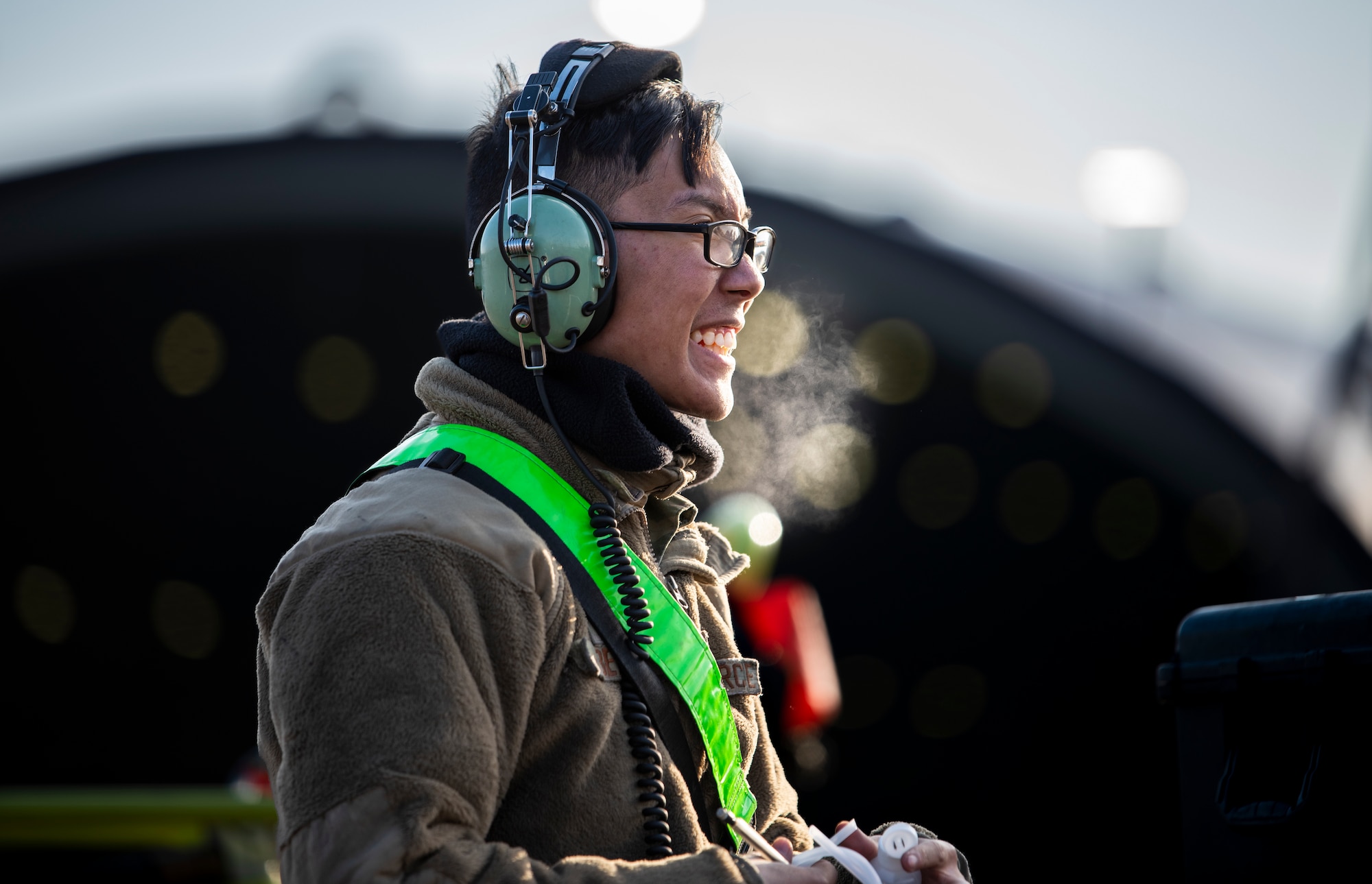 U.S. Air Force Senior Airman Anjo Betita, 25th Fighter Generation Squadron (FGS) crew chief, smiles on the flightline at Osan Air Base, Republic of Korea, Dec. 7, 2022.