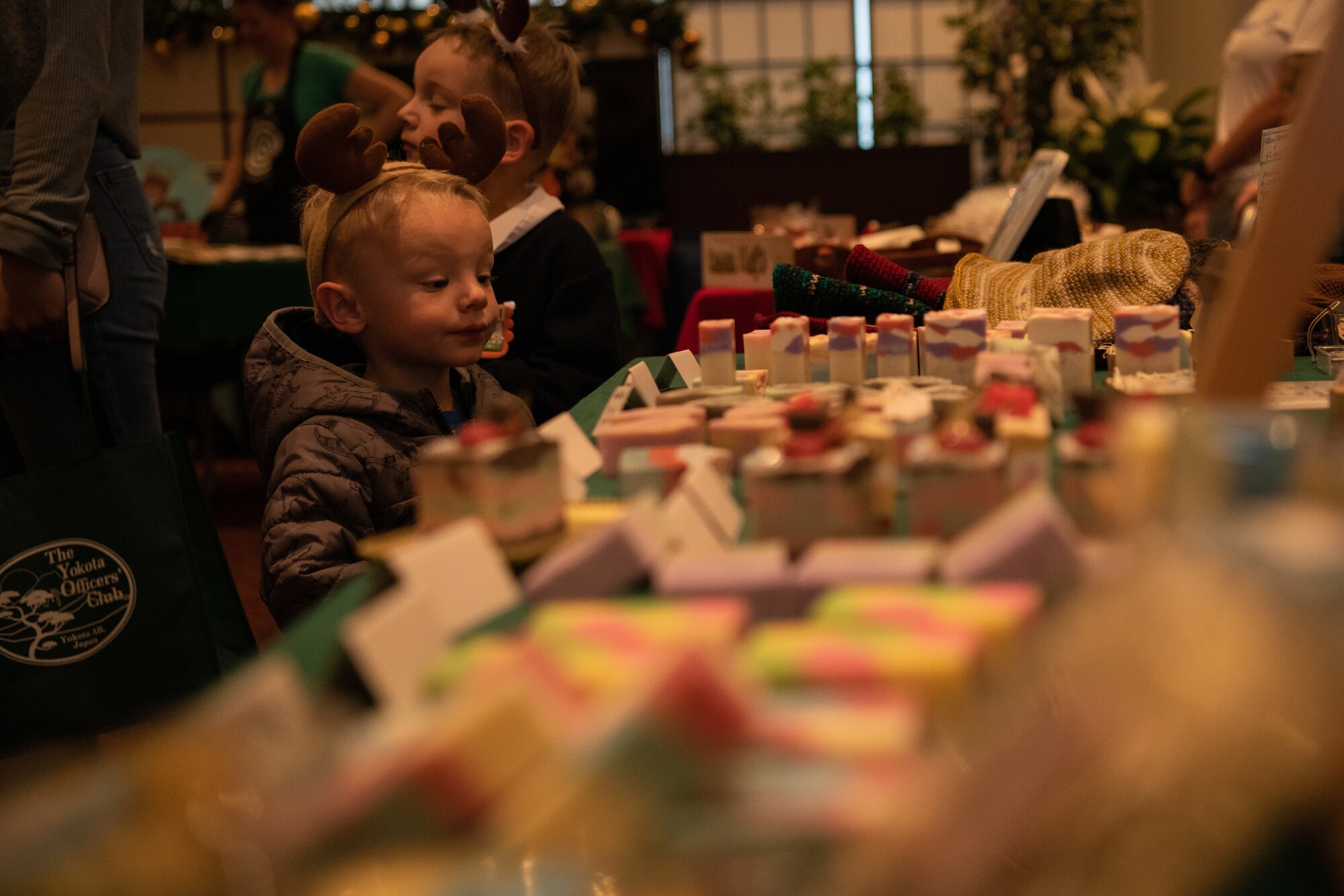Child looks at artisan crafted products.