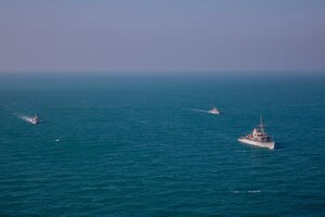221211-A-NR779-1045 ARABIAN GULF (Dec. 11, 2022) U.S. Navy mine countermeasures ship USS Dextrous (MCM 13), right, operates in the Arabian Gulf with ships from the Iraq Navy and Kuwait Coast Guard, Dec. 11. Iraq, Kuwait and the United States completed a joint patrol in the Arabian Gulf for the second time in four months to promote regional maritime security.