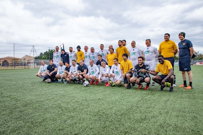 221129-N-OK195-1104 LE MUY, France (Nov. 29, 2022) Sailors assigned to the Arleigh Burke-class guided-missile destroyer USS Truxtun (DDG 103) and firefighters from the Emergency Coordination Center pose for a photo after a soccer match, Nov. 29, 2022. Truxtun, as part of the George H.W. Bush Carrier Strike Group, is on a scheduled deployment in the U.S. Naval Forces Europe-Africa area of operations, employed by U.S. Sixth Fleet to defend U.S., allied, and partner interests (U.S. Navy photo by Mass Communication 2nd Class Specialist Porsha Thompson)