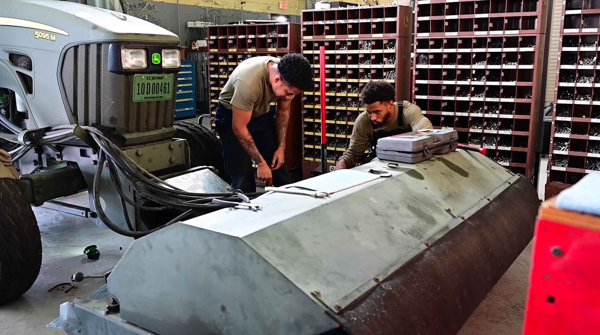 Two 8th Logistics Readiness Squadron vehicle maintenance personnel work on a foreign object debris vehicle at Kunsan Air Base, Republic of Korea, Nov. 21, 2022. The vehicle maintenance flight works on vehicles from diesel to electric. (U.S. Air Force photo by Staff Sgt. Sadie Colbert)