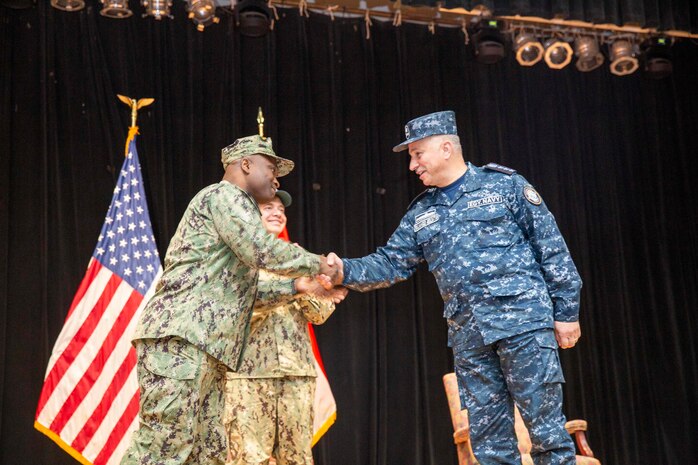 MANAMA, Bahrain (Dec. 12, 2022) Egyptian Navy Rear Adm. Mahmoud Abdelsattar, right, shakes hands with Capt. Robert Francis, the outgoing commander of Combined Task Force (CTF) 153, during a change of command ceremony in Manama, Bahrain, Dec. 12. Francis turned over U.S. Navy command of the newly formed international Red Sea task force, CTF 153, to the Egyptian Navy during a ceremony in Bahrain where the multinational staff is headquartered.