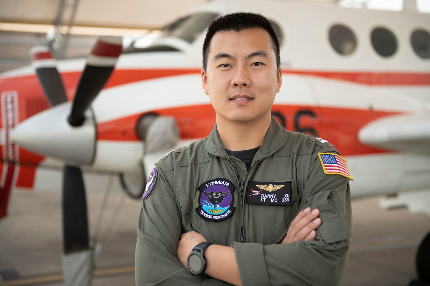 Lt. Danny Xu stands on the flight line of Naval Air Station Corpus Christi in front of a T-44 Pegasus, May 11.