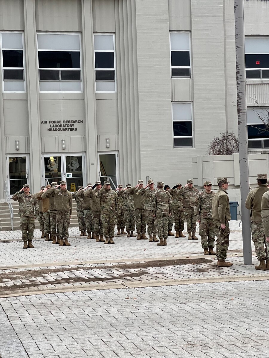 Thirty-two active-duty Airmen and Guardians from the Air Force Research Laboratory, or AFRL, conducted a Retreat ceremony Dec. 5, 2022 at 5 p.m. in front of AFRL headquarters, building 15 at Wright-Patterson Air Force Base, Ohio. Col. Joel Luker, AFRL vice commander, led the formation for the Retreat ceremony, which honors the U.S. flag when lowered in the evening and signals the end of the duty day. A seven-member flag detail accomplished the flag lowering and folding, while 25 others rendered salutes in formation. (U.S. Air Force photo / 1st Lt. Isaiah Sanders)