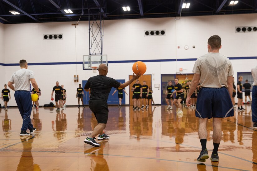 Senior Enlisted Advisor Tony Whitehead participates in dodgeball during physical training with the University of Kentucky Air and Army Reserves Officer Training Corp (ROTC) at the University of Kentucky's Seaton Center in Lexington, Ky. on Dec. 5, 2022. Whitehead is visiting Kentucky to recognize soldiers and airmen for their accomplishments throughout the year and meet with local ROTC cadets. (U.S. Army photo by Staff Sgt. Andrew Dickson)