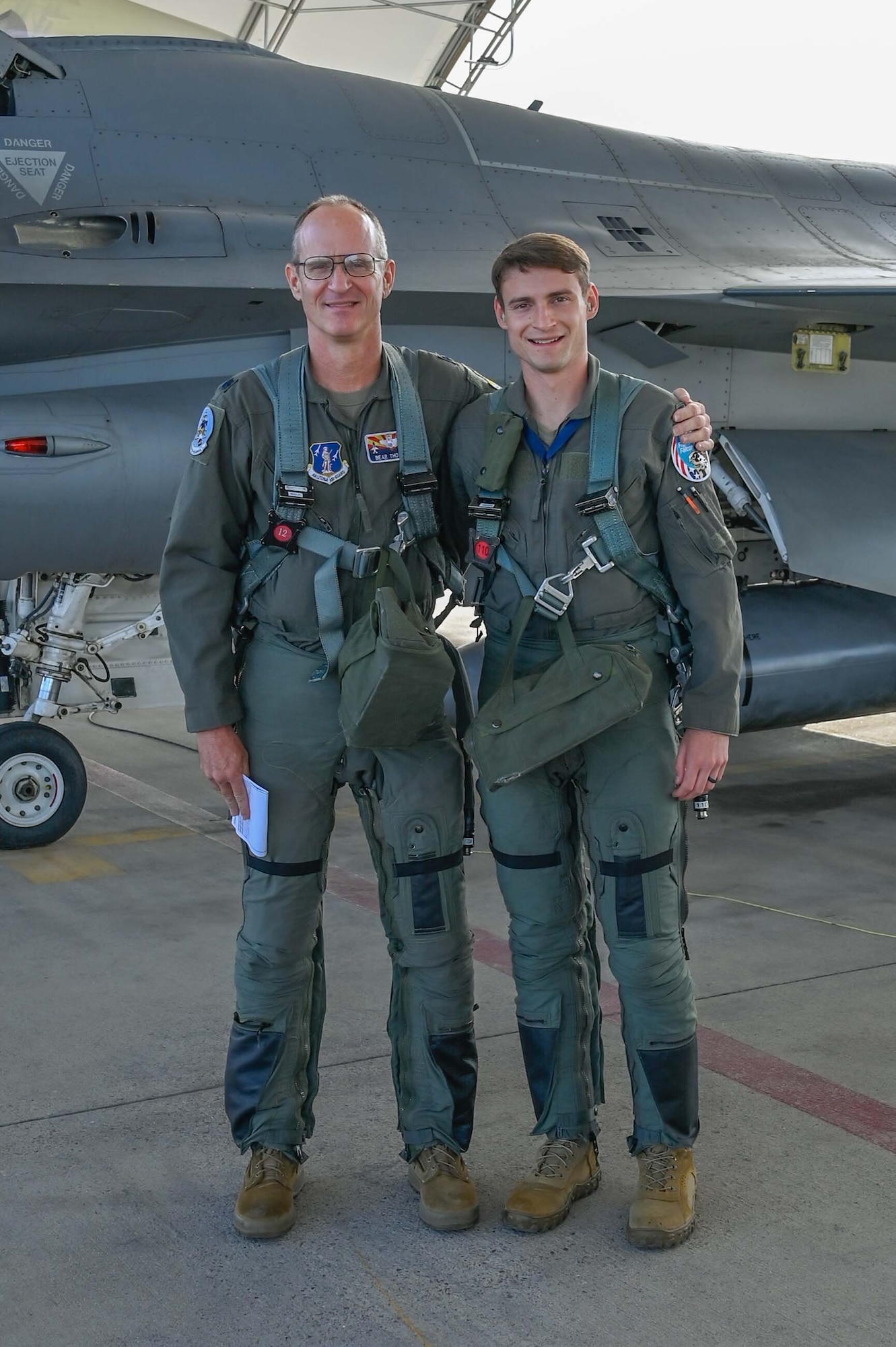 Lt. Col. Joseph Thomas, a Drill Status Guardsman F-16 instructor pilot with the 162nd Wing in Tucson, Ariz., and his son, 1st Lt. Nathan Thomas, an active-duty F-16 student pilot, prepare to fly a training mission in the F-16 Fighting Falcon. (U.S. Air National Guard photo by Maj. Angela Walz)