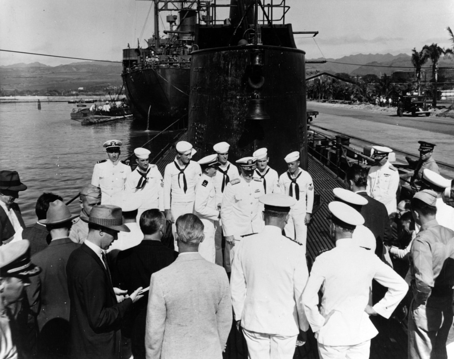 Admiral Nimitz assumes command of the US Pacific Fleet in a ceremony aboard USS Grayling (SS-209) on 31 December 1941.