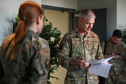 U.S. Air Force Maj. Gen. Joel Jackson, commander of the Air Force District of Washington, reviews educational programs provided by Tech Sgt. Sarah Rodulfo, 11th Force Support Squadron professional development NCO at Joint Base Anacostia-Bolling, Washington D.C., Dec. 8, 2022. Jackson had the opportunity to learn how JBAB missions are aligning with the AFDW vision of “Ready Airmen, Renowned for Excellence, Worldwide.”