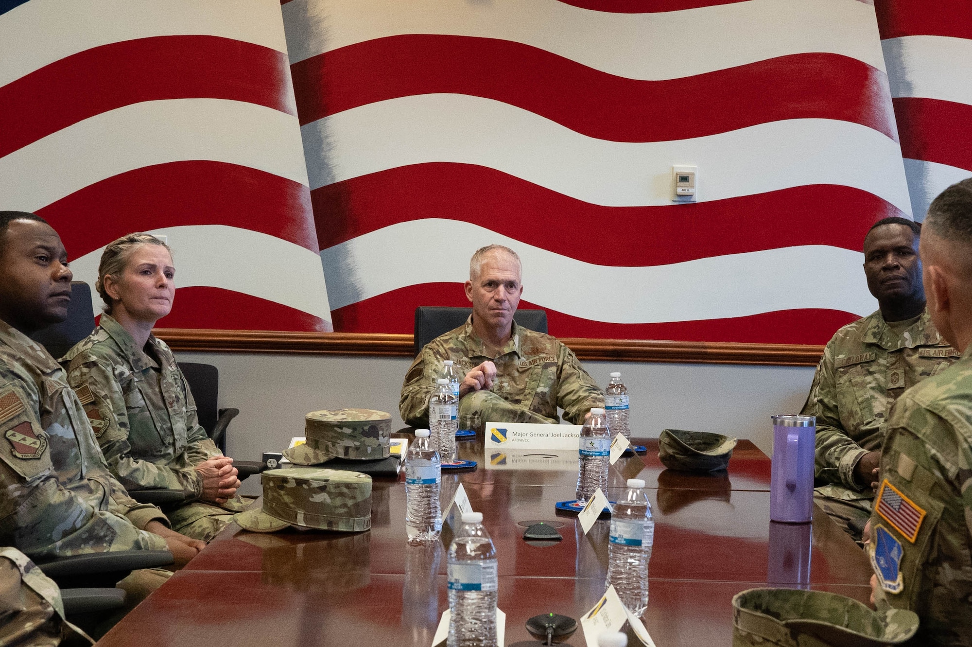 U.S. Air Force Maj. Gen Joel Jackson (center), commander of the Air Force District of Washington and U.S Air Force Chief Master Sgt. Leon Calloway (right), command chief of AFDW, meet with wing leadership during a tour at Joint Base Anacostia-Bolling, Washington D.C., Dec. 8, 2022. The command team learned how JBAB has proactively strengthened and prioritized readiness, development, and partnerships with key mission partners on the installation and in the local community since the lead service transfer from the U.S. Navy to the U.S. Air Force in October 2020. (U.S. Air Force photo by Airman 1st Class Bill Guilliam)