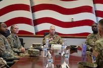 U.S. Air Force Maj. Gen Joel Jackson (center), commander of the Air Force District of Washington and U.S Air Force Chief Master Sgt. Leon Calloway (right), command chief of AFDW, meet with wing leadership during a tour at Joint Base Anacostia-Bolling, Washington D.C., Dec. 8, 2022. The command team learned how JBAB has proactively strengthened and prioritized readiness, development, and partnerships with key mission partners on the installation and in the local community since the lead service transfer from the U.S. Navy to the U.S. Air Force in October 2020. (U.S. Air Force photo by Airman 1st Class Bill Guilliam)