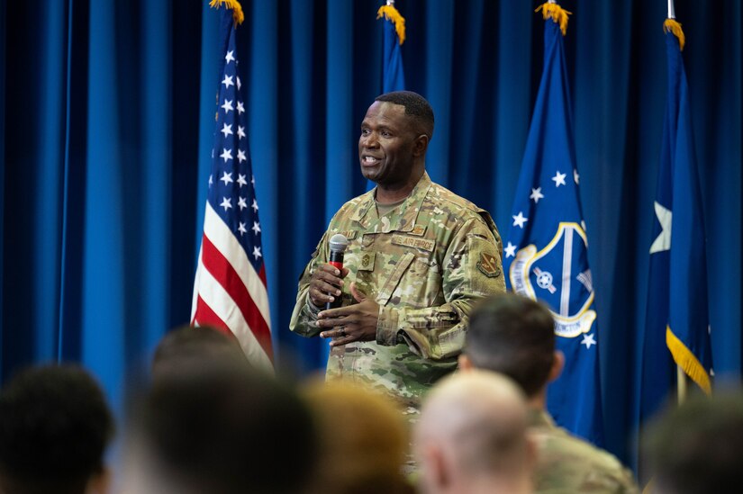 U.S Air Force Chief Master Sgt. Leon Calloway, command chief of the Air Force District of Washington, speaks at an all-call at Joint Base Anacostia-Bolling, Washington D.C., Dec. 8, 2022. After visiting various sections of the wing, the AFDW command team held an all-call to speak, take questions, and recognize the achievements of JBAB Airmen. (U.S. Air Force photo by Airman 1st Class Bill Guilliam)