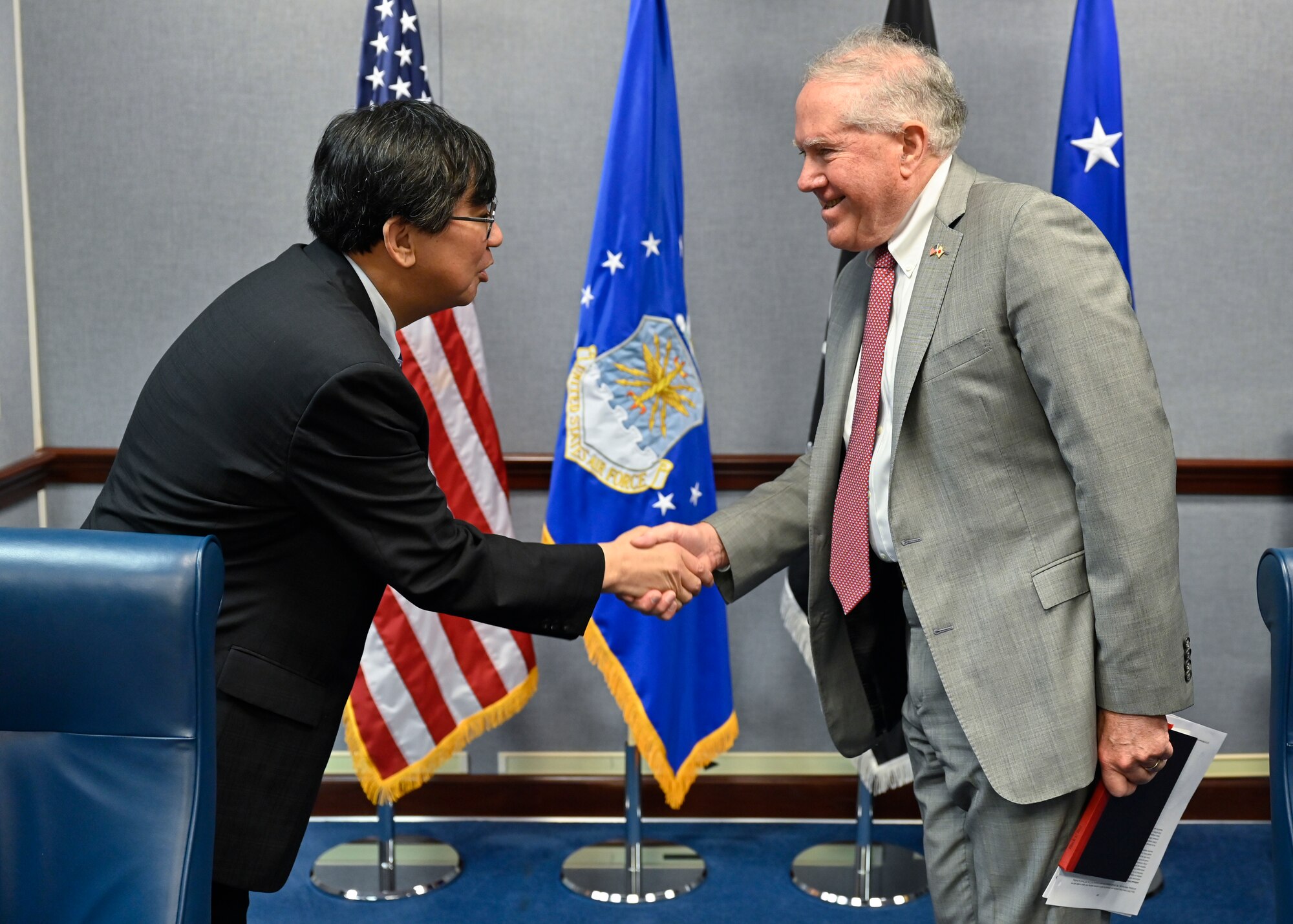 Secretary of the Air Force Frank Kendall, right, greets Hideki Tsuchimoto, commissioner of the Acquisition, Technology and Logistics Agency, Japanese Ministry of Defense.