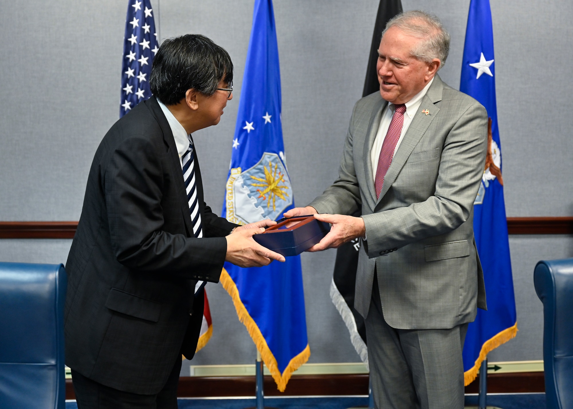 Secretary of the Air Force Frank Kendall, right, exchanges gifts with Hideki Tsuchimoto, commissioner of the Acquisition, Technology and Logistics Agency, Japanese Ministry of Defense.