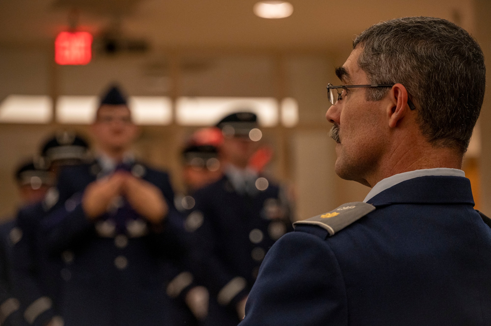 Lt. Col. David Ramirez, 916th Operations Support Squadron deputy chief of wing intelligence and Goldsboro Civil Air Patrol instructor, listens to a brief about the history of the 4th Fighter Wing Honor Guard at Seymour Johnson Air Force Base, North Carolina, Dec. 7, 2022. Ramirez has volunteered with the Goldsboro CAP group for three years, and continues to help promote activities to develop leaders and inform them about the military. (U.S. Air Force photo by Airman 1st Class Sabrina Fuller)