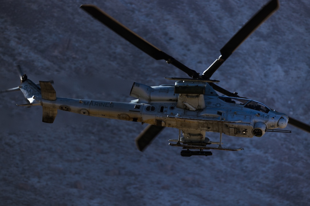 A U.S. Marine AH-1Z Viper helicopter with Marine Light Attack Helicopter Squadron 169, Marine Aircraft Group 39, 3rd Marine Aircraft Wing, flies toward its target during a fire support coordination exercise with Marines from 1st Marine Division as part of Steel Knight 23 at Marine Corps Air Ground Combat Center Twentynine Palms, California, Nov. 30, 2022. Steel Knight is an annual combined arms live-fire exercise which ensures 1st MARDIV is optimized for naval expeditionary warfare in contested spaces, and is purpose-built to facilitate future operations afloat and ashore. (U.S. Marine Corps photo by Lance Cpl. Barton)