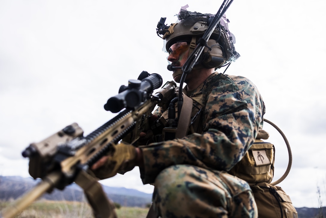 U.S. Marine Cpl. Schultz, a squad leader with Lima Company, 3rd Battalion, 1st Marine Regiment, 1st Marine Division, posts security during a patrol as part of Steel Knight 23 at Marine Corps Base Camp Pendleton, California, Dec. 6, 2022. Steel Knight is an annual combined arms live-fire exercise which ensures 1st MARDIV is optimized for naval expeditionary warfare in contested spaces, and is purpose-built to facilitate future operations afloat and ashore. Schultz is a native of Glastonbury, Connecticut. (U.S. Marine Corps photo by Lance Cpl. Daniel)