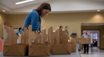 Volunteers prepare to box up holiday cookies.