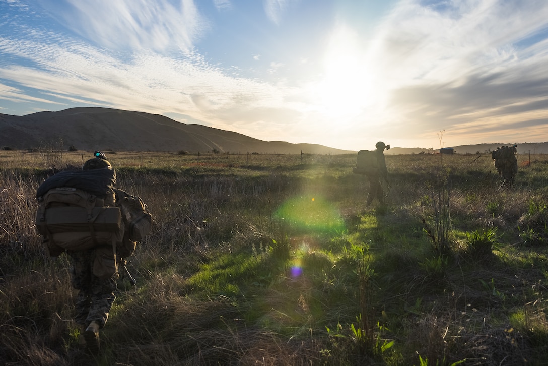U.S. Marines with Lima Company, 3rd Battalion, 1st Marine Regiment, 1st Marine Division, patrol toward an objective during an air assault as part of Steel Knight 23 at Marine Corps Base Camp Pendleton, California, Dec. 5, 2022. Steel Knight is an annual combined arms live-fire exercise which ensures 1st MARDIV is optimized for naval expeditionary warfare in contested spaces, and is purpose-built to facilitate future operations afloat and ashore. (U.S. Marine Corps photo by Lance Cpl. Daniel)