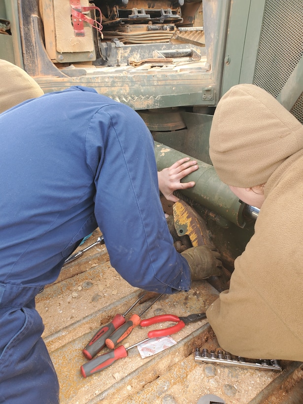 Col Scottie Redden, Detachment CO, turns wrenches with the Engineer Maintenance Marines.