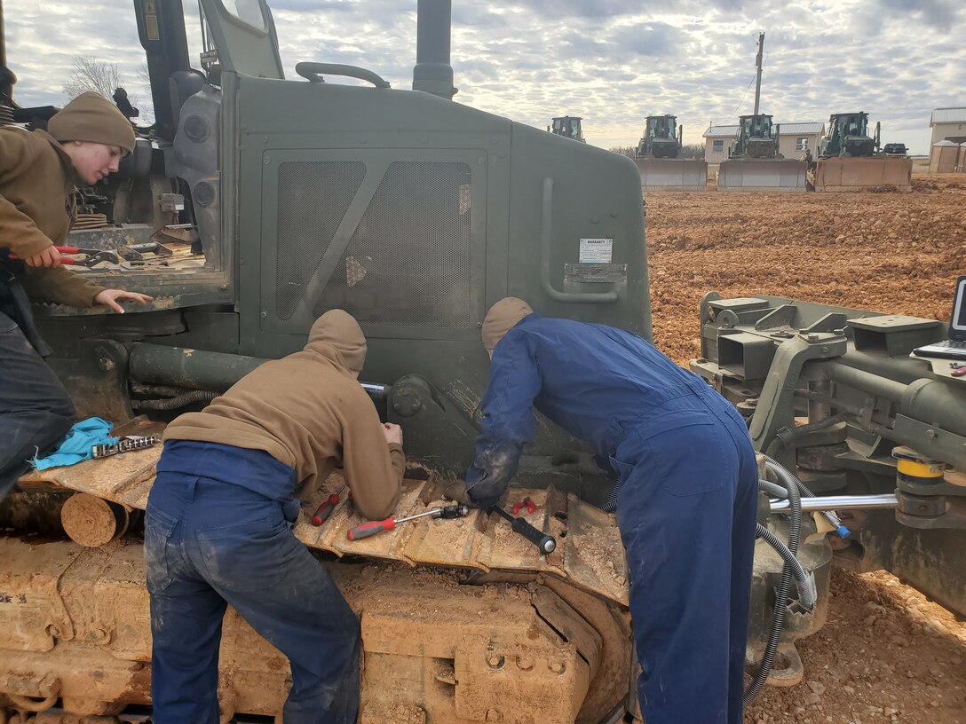 Col Scottie Redden, Detachment CO, turns wrenches with the Engineer Maintenance Marines.
