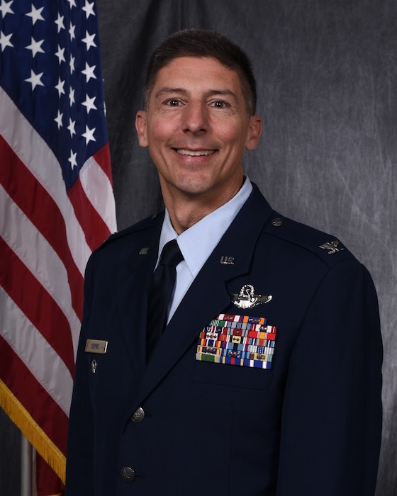 Col. Christopher J. Sopko poses for an official photo with a gray background.