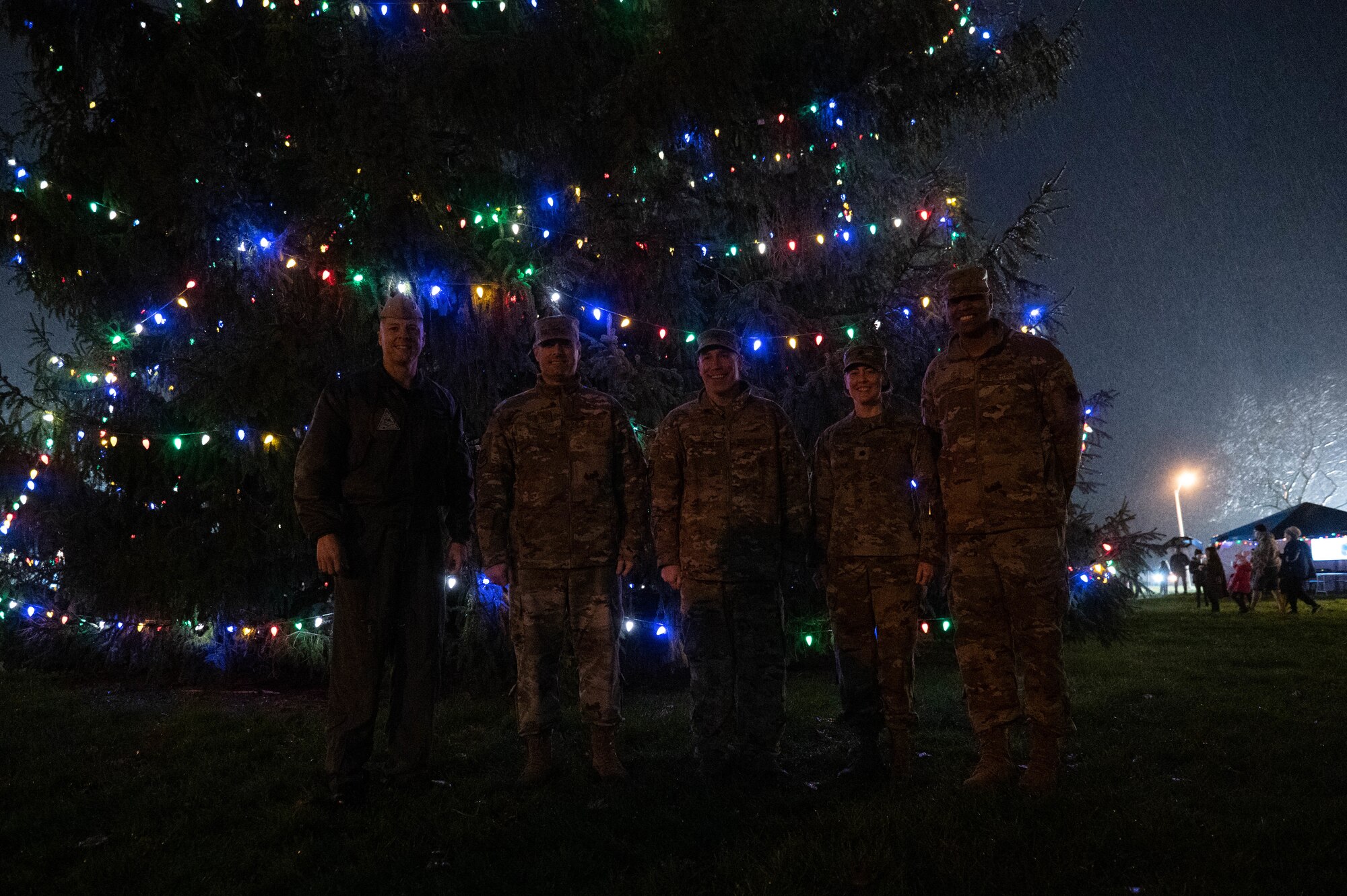 Joint Base MDL leadership smiles for a group photo during the annual JB MDL holiday tree lighting ceremony on Joint Base McGuire-Dix-Lakehurst, N.J., Dec. 6, 2022. The annual JB MDL holiday tree lighting ceremony featured a variety of festivities, such as: horse-and-carriage rides, funnel cakes, pretzels, hot chocolate, and meeting in-person with Mr. and Mrs. Claus. The annual tree lighting ceremony is an opportunity for JB MDL families to come together at the start of the holiday season. (U.S. Air Force photo by Senior Airman Faith Iris MacIlvaine)