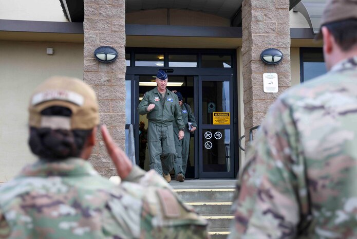 Airmen with the 9th Reconnaissance Wing salute U.S. Air Force Gen. Mark Kelly, commander of Air Combat command, during his visit to Beale Air Force Base, Calif. on Dec. 6, 2022.