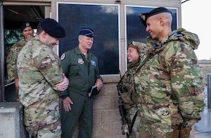U.S. Air Force Gen. Mark Kelly, commander of Air Combat Command, engages with members of the 9th Security Forces Squadron while visiting Beale Air Force Base, Calif., on Dec. 6, 2022.