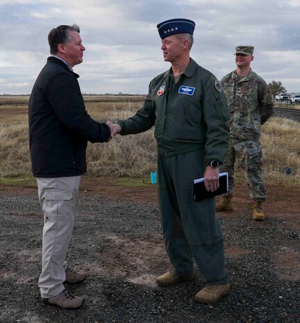 U.S. Air Force Gen. Mark Kelly, commander of Air Combat Command, coins John Shaw, 9th Communications Squadron Telecommunications Technician, at Beale Air Force Base, Calif. on Dec. 6, 2022.