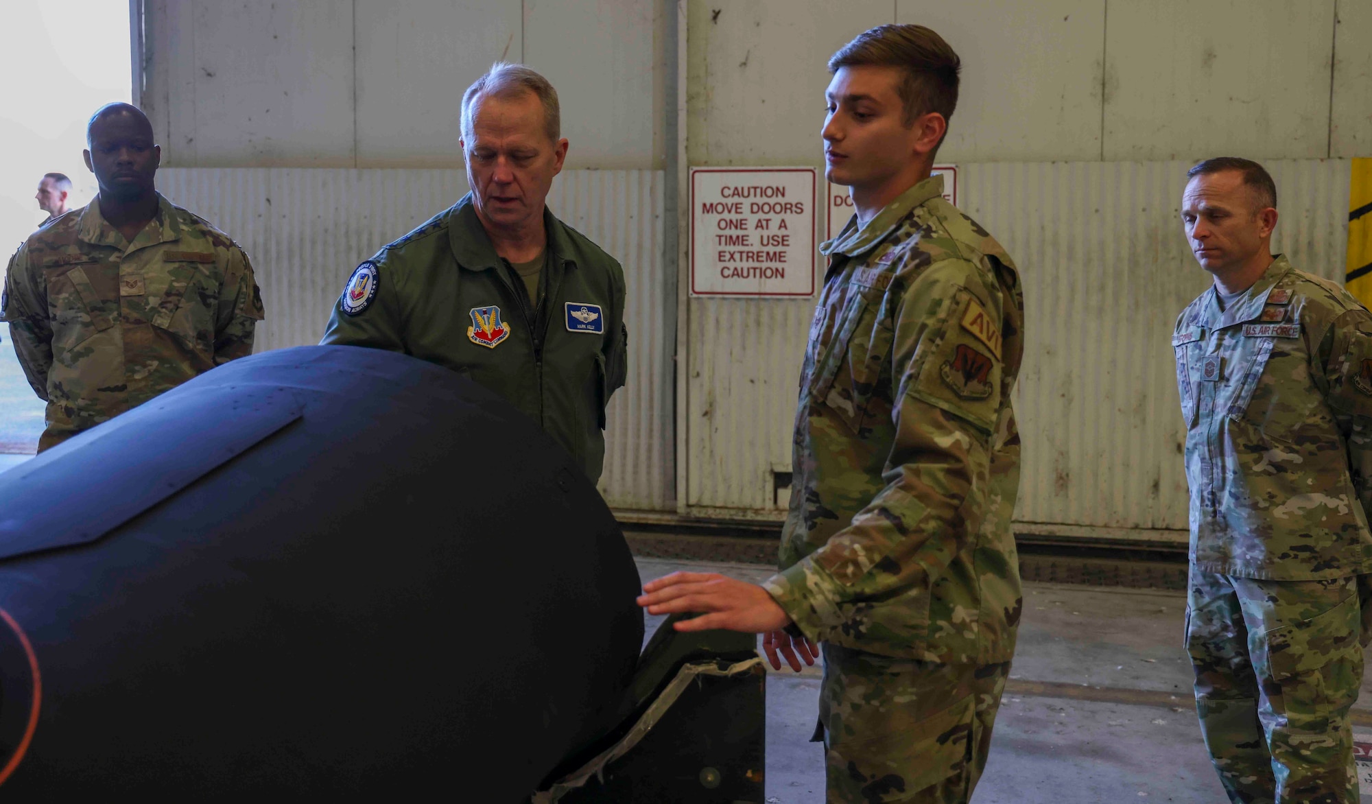 U.S. Air Force Staff Sgt. Evan Piron, 9th Aircraft Maintenance Squadron, demonstrates U-2 Dragon Lady modifications to Gen. Mark Kelly, commander of Air Combat Command, at Beale Air Force Base, Calif. on Dec. 6, 2022.