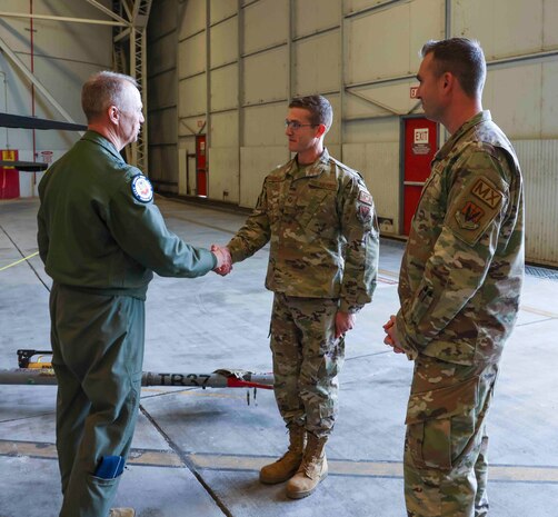 U.S. Air Force Gen. Mark Kelly, commander of Air Combat Command, coins Staff Sgt. Michael Hirsch, 9th Aircraft Maintenance Squadron, at Beale Air Force Base, Calif. on Dec. 6, 2022.