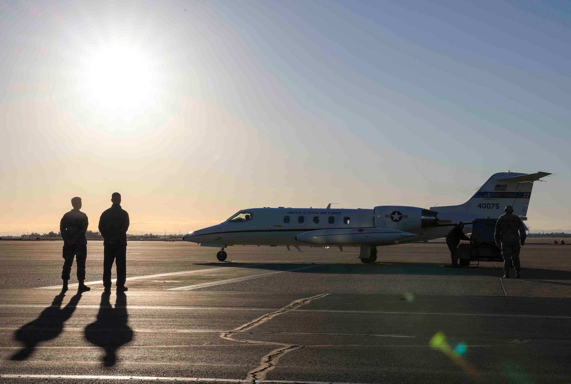 U.S. Air Force Col. Geoffrey Church, 9th Reconnaissance Wing commander, and 9th Reconnaissance Wing Command Chief Master Sgt. Breanna Oliver look on the departure of Gen. Mark Kelly, commander of Air Combat Command, and Air Combat Command Chief Master Sgt. John Storms from Beale Air Force Base, Calif. on Dec. 6, 2022.