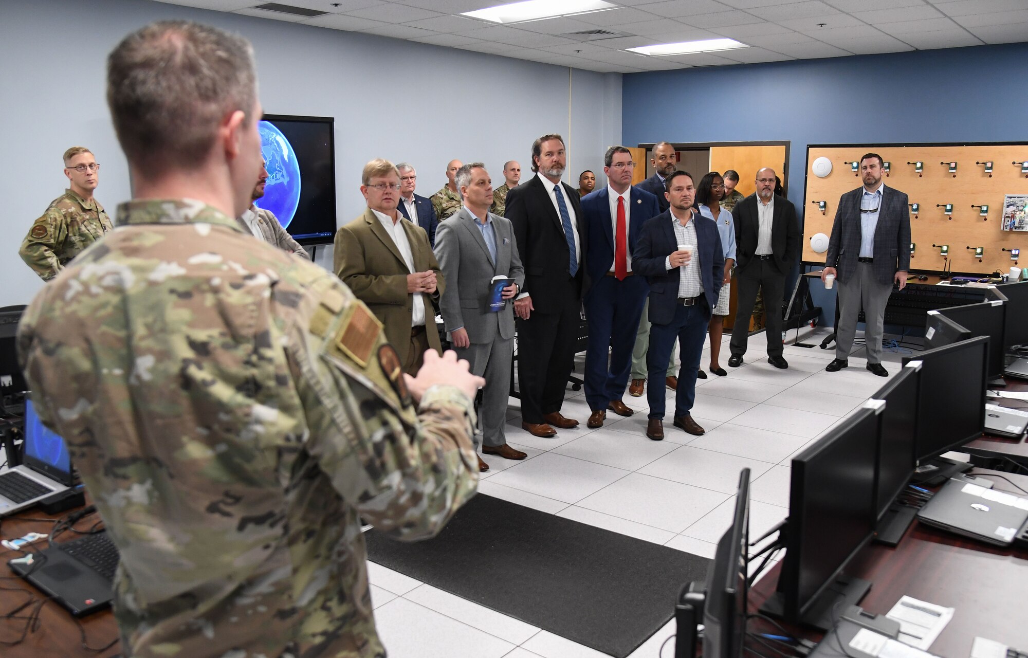 U.S. Air Force Master Sgt. Tanner Thomas, 333rd Training Squadron director of operations, briefs state and local civic leaders on the 333rd TRS cyber training capabilities during A Day At Keesler inside Stennis Hall at Keesler Air Force Base, Mississippi, Dec. 9, 2022.