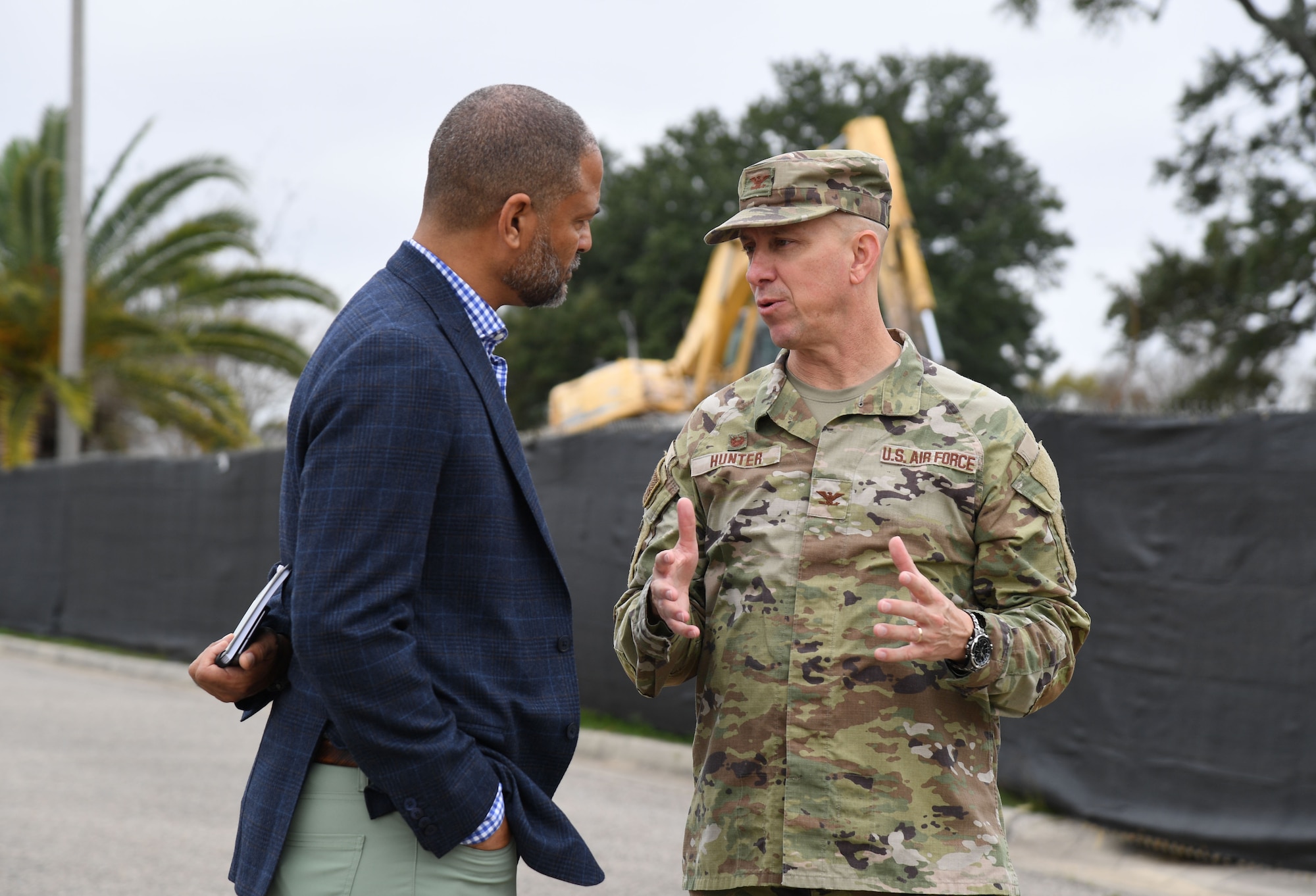 U.S. Air Force Col. William Hunter, 81st Training Wing commander, discusses the new Mississippi Cyber Center construction project with Jonathan Fleming, S2 Global president, during A Day At Keesler at Keesler Air Force Base, Mississippi, Dec. 9, 2022.