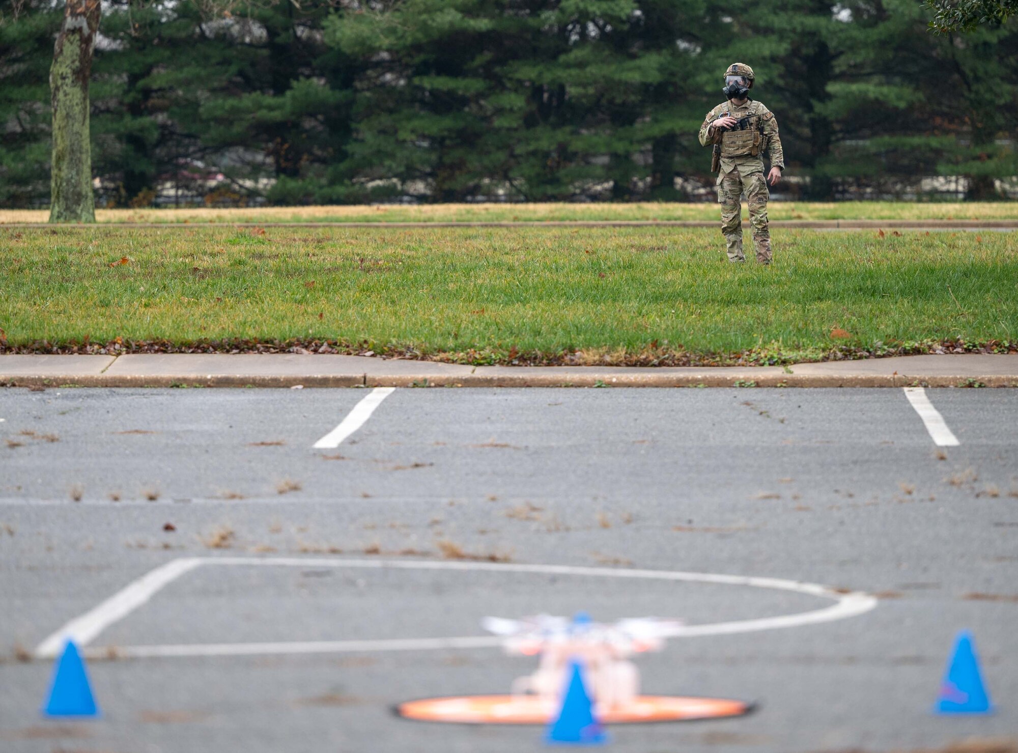 Staff Sgt. Jordan Meadow, 436th Security Forces Squadron force response leader, cordons an unidentified explosive device during a major accident response exercise at Dover Air Force Base, Delaware, Dec. 7, 2022. The three-day exercise tested the response capabilities of Team Dover through various scenarios in an effort to strengthen their ability to provide rapid-global mobility in challenging conditions. (U.S. Air Force photo by Senior Airman Faith Barron)