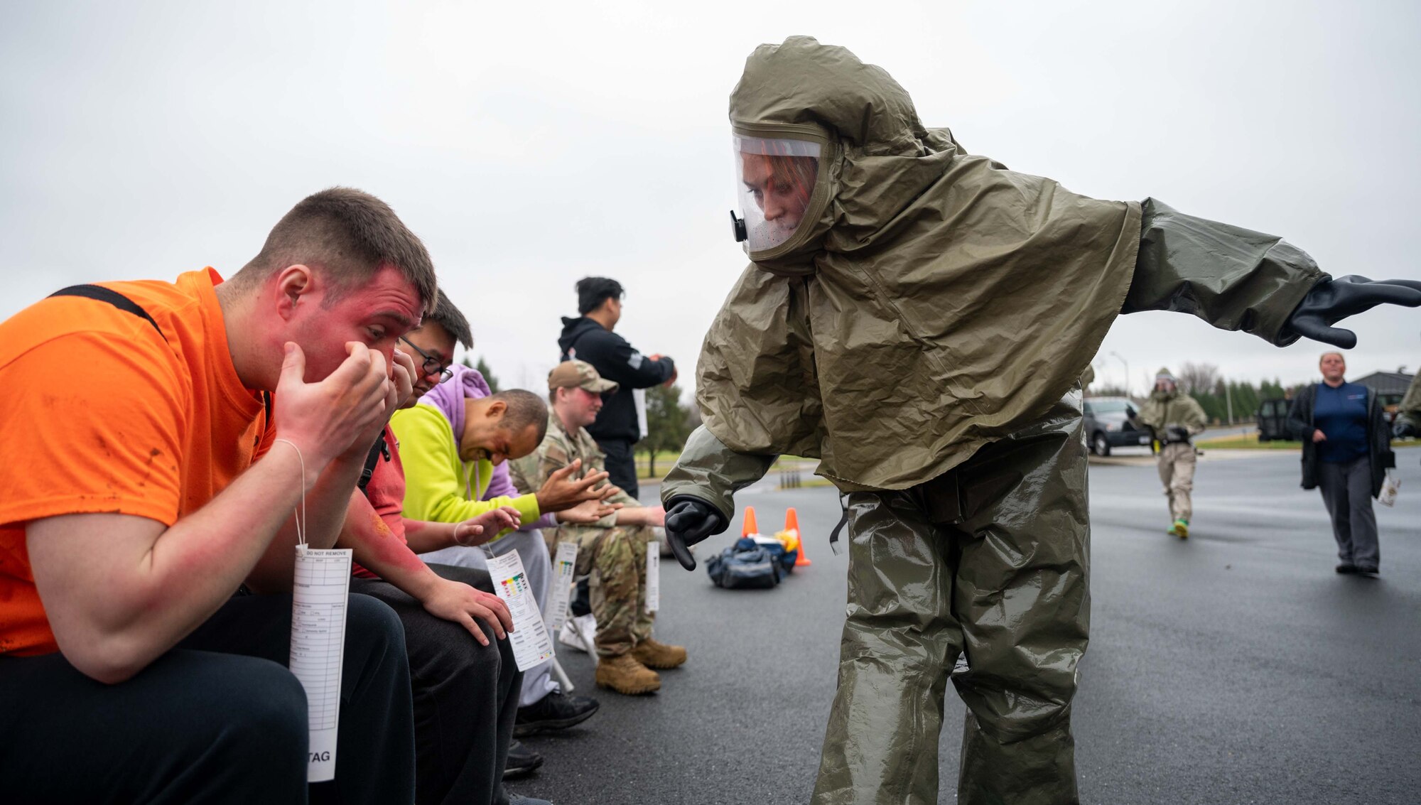 Team Dover Airmen portraying burn victims wait for medical help during a major accident response exercise at Dover Air Force Base, Delaware, Dec. 7, 2022. The exercise tested the capabilities of the 436th Airlift Wing and the 512th AW. (U.S. Air Force photo by Senior Airman Faith Barron)