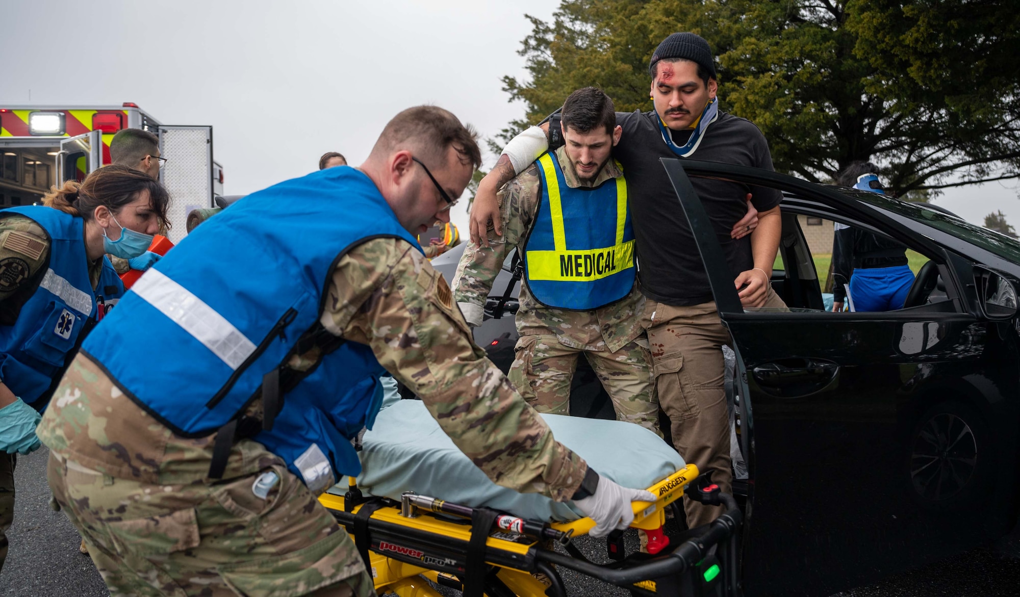 Members from the 436th Operational Medical Readiness Squadron ambulance response team, assist a simulated car crash victim during a major accident response exercise at Dover Air Force Base, Delaware, Dec. 7, 2022. The three-day exercise tested the response capabilities of Team Dover through various scenarios in an effort to strengthen their ability to provide rapid-global mobility in challenging conditions. (U.S. Air Force photo by Senior Airman Faith Barron)