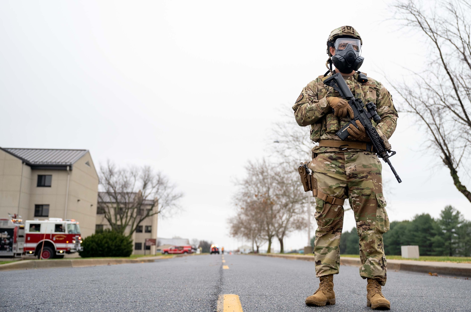 Master Sgt. James Marks, 436th Security Forces Squadron training section chief, stands guard during a major accident response exercise at Dover Air Force Base, Delaware, Dec. 7, 2022. During the exercise, the base was tested on scenarios to ensure proper procedures are being followed during an emergency. (U.S. Air Force photo by Senior Airman Faith Barron)