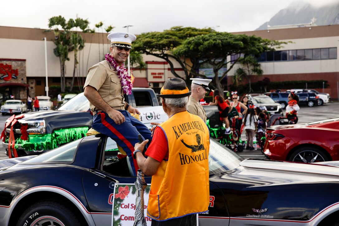 U.S. Marine Corps Col. Speros Koumparakis, commanding officer, Marine Corps Base Hawaii, greets parade participants and volunteers during the Kaneohe Holiday Parade, Kaneohe, Hawaii, Dec. 3, 2022. Base leadership participated in the event in order to commence the start of the holiday season and strengthen relationships between MCBH and the local community. (U.S. Marine Corps photo by Cpl. Samantha Sanchez)