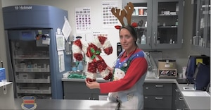 Female stands in medical office holding holiday decorations