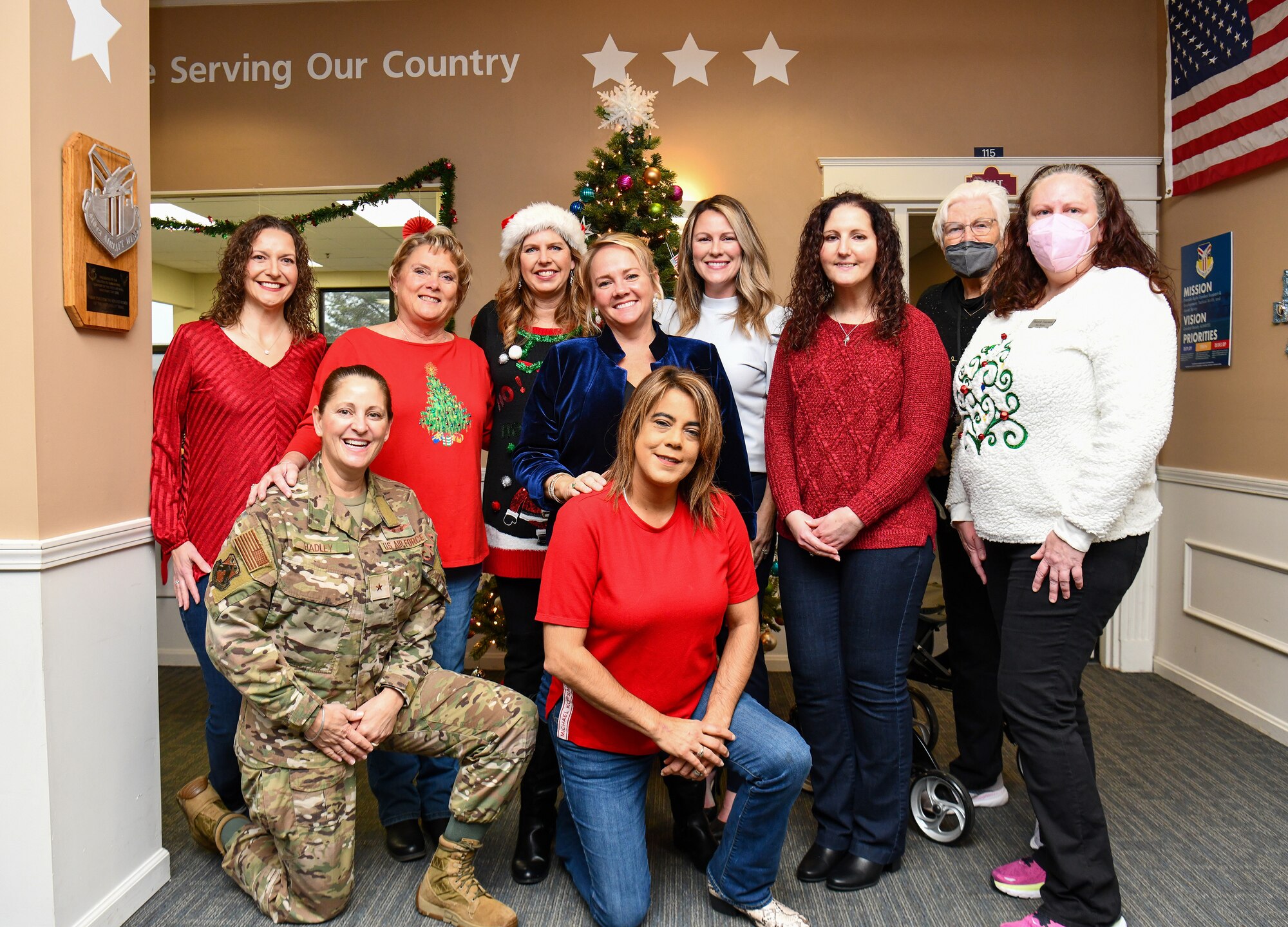Brig. Gen. Leslie S. Hadley, mobilization assistant to the commander assigned to the 18th Air Force, poses for a picture with 910th Airlift Wing Key Spouses during a visit at Youngstown Air Reserve Station, Dec. 3, 2022.