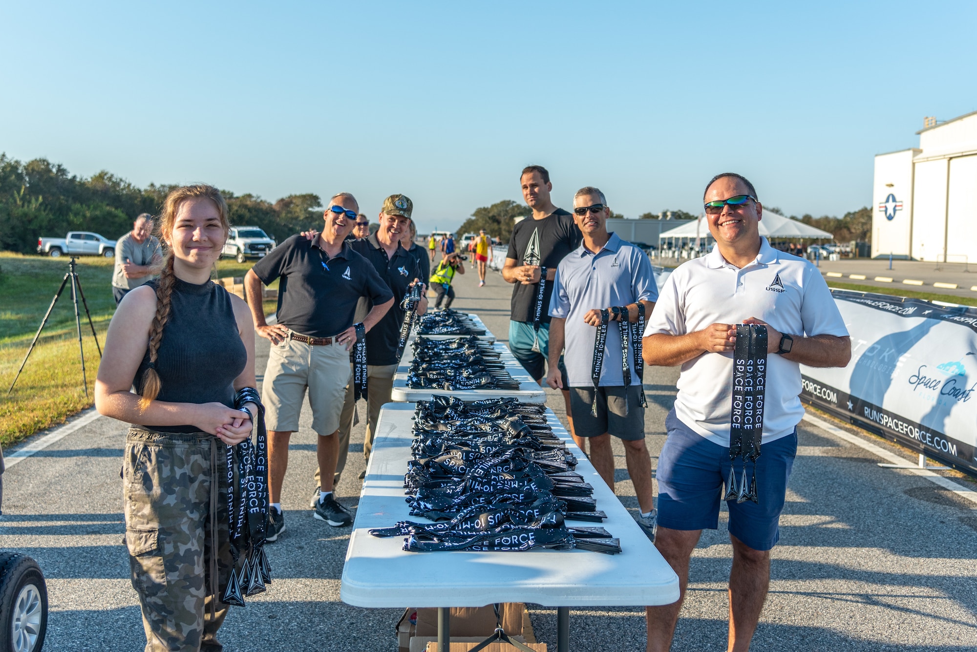 T-Minus 10-Miler event staff prepare to hand medals to participants crossing the finish line on Dec. 10, 2022 at Cape Canaveral Space Force Station, Fla. The T-Minus 10-Miler celebrates the Space Forces birthday.