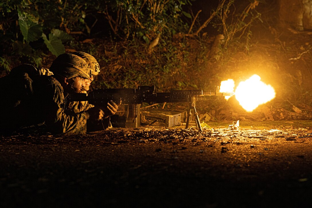 U.S. Marine Corps Lance Cpl. Luis DelacruzRios, a motor transport operator, and Cpl. Samuel Llamas, a combat engineer, both with 3rd Landing Support Battalion, Combat Logistics Regiment 3, 3rd Marine Logistics Group, execute a simulated convoy ambush with an M240B medium machine gun during exercise Winter Workhorse, at Central Training Area, Camp Hansen, Okinawa, Japan, Dec. 6, 2022. Winter Workhorse is an annual exercise for CLR-3 to train to carry out mission essential tasks in forward-deployed, austere environments. (U.S. Marine Corps photo by Lance Cpl. Weston Brown)