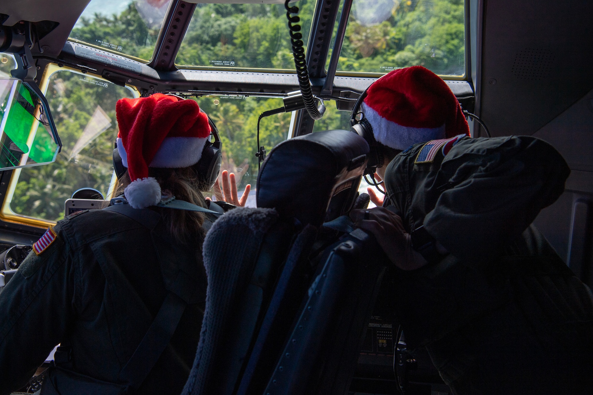 U.S. Air Force pilots wave to island community members.