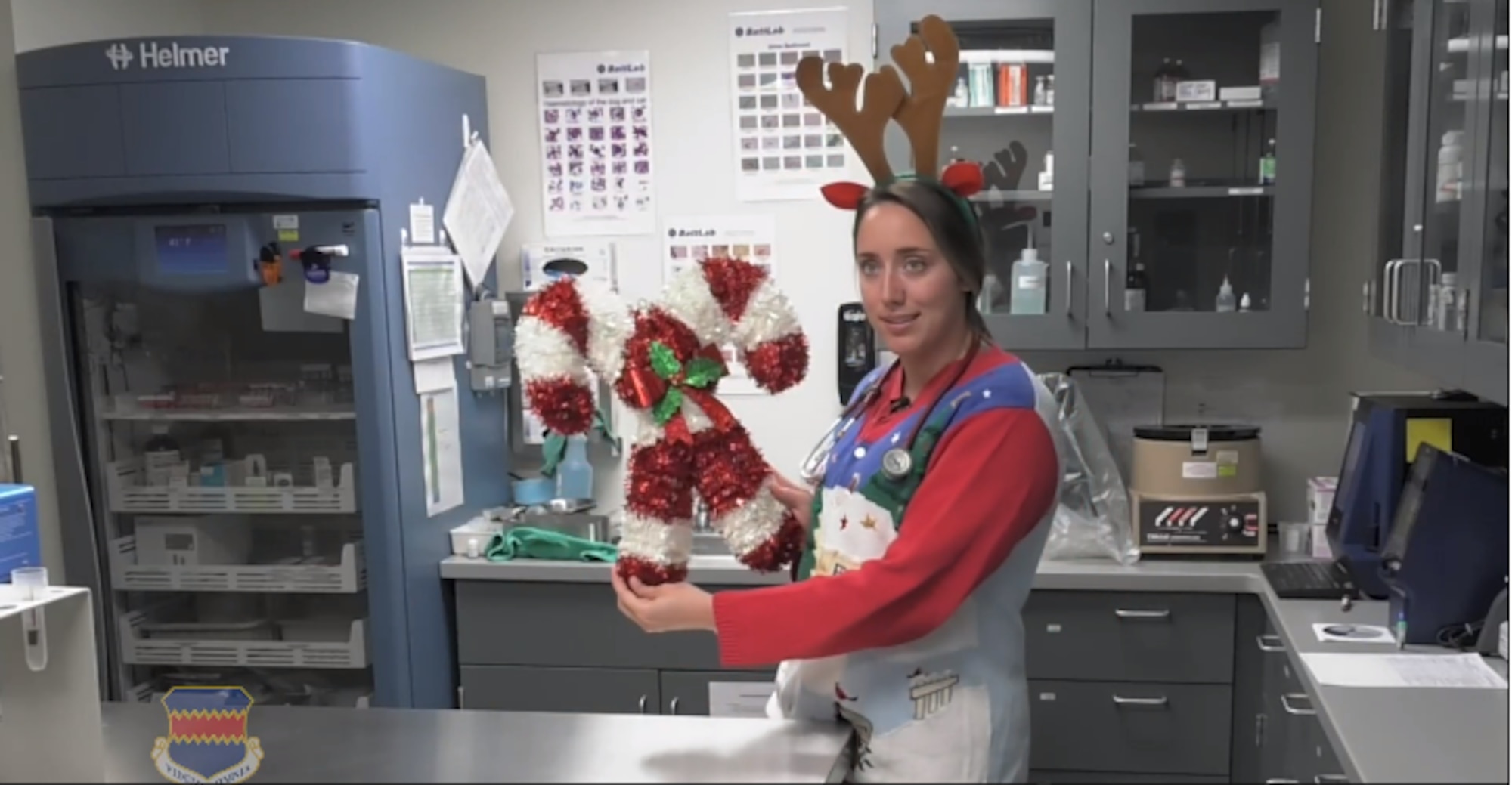 Female stands in medical office holding holiday decorations