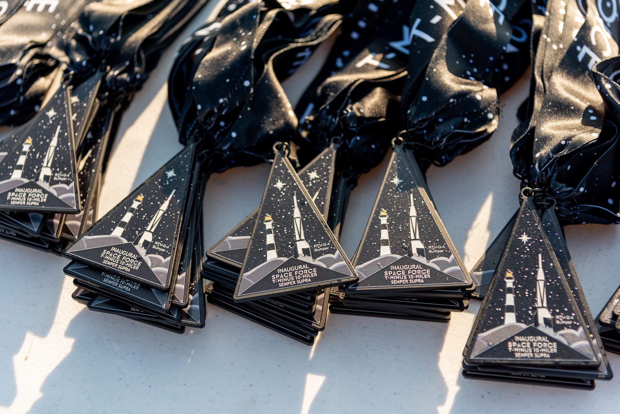 T-Minus 10-Miler participant medals stacked on a table on Dec. 10, 2022 at Cape Canaveral Space Force Station, Fla. The T-Minus 10-Miler celebrates the Space Forces birthday.