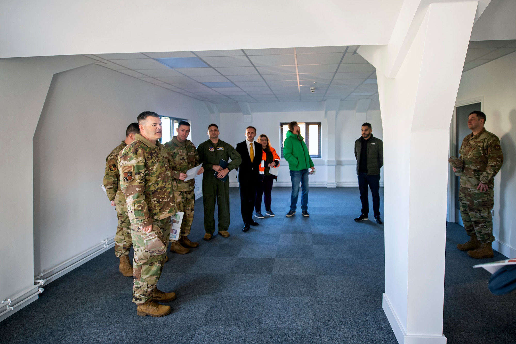 U.S. Air Force Col. Brian Filler, center, 501st Combat Support Wing commander, speaks during the unveiling of the new 501st CSW headquarters building at RAF Fairford, England, Dec. 6, 2022. The Pathfinder command team marked the beginning of the headquarters transfer from RAF Alconbury to RAF Fairford. (U.S. Air Force photo by Staff Sgt. Eugene Oliver)