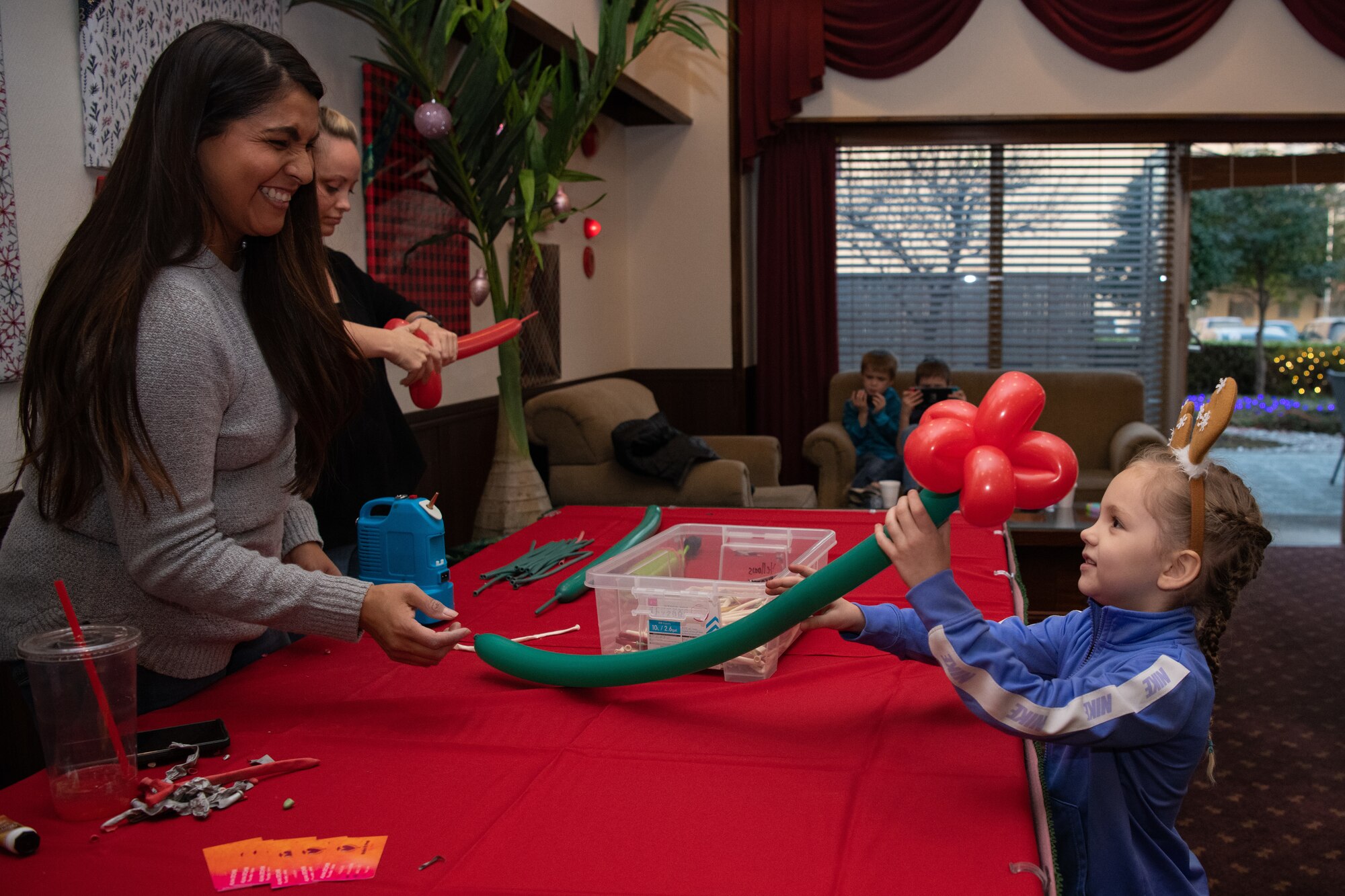 Vendor hands a child a balloon.